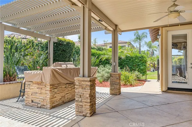 a view of a patio with table and chairs potted plants with floor to ceiling window
