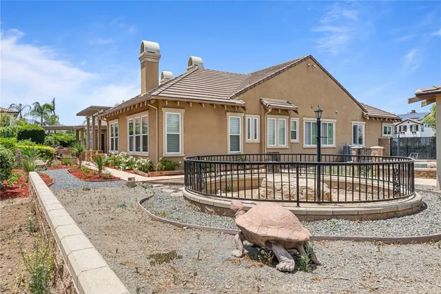 a view of a porch with a floor to ceiling window and potted plants