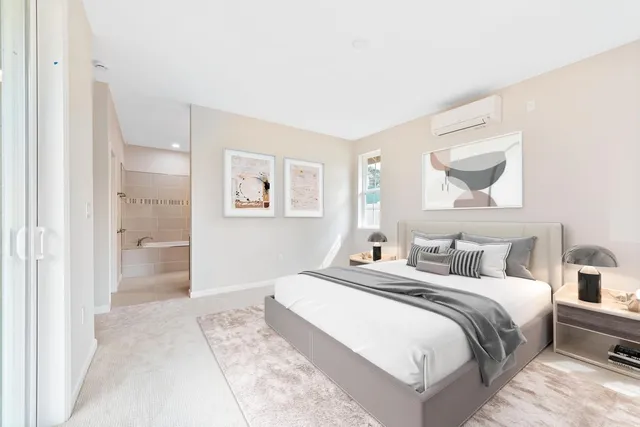 a bedroom with a bed and a painting on the wall