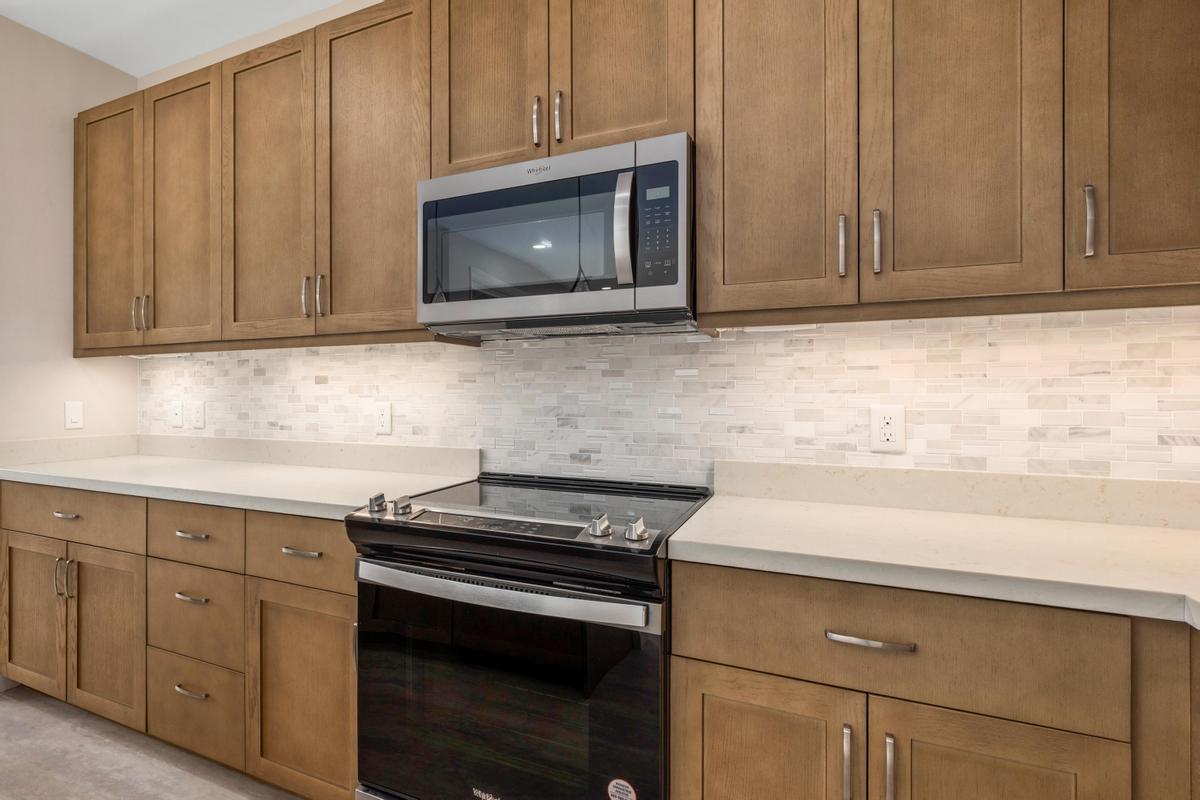 75-3744 Leialii Loop Kailua-Kona, HI 96740 - Photo 6 of 10 a kitchen with granite countertop cabinets stainless steel appliances and wooden cabinets
