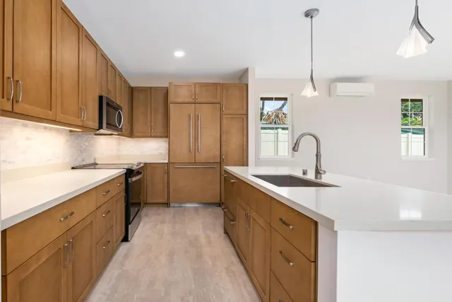 a kitchen with stainless steel appliances a sink stove and refrigerator