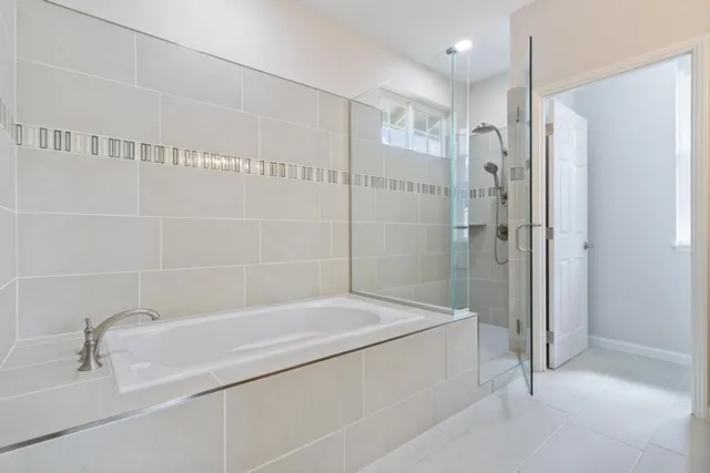 a bathroom with a bathtub and a shower