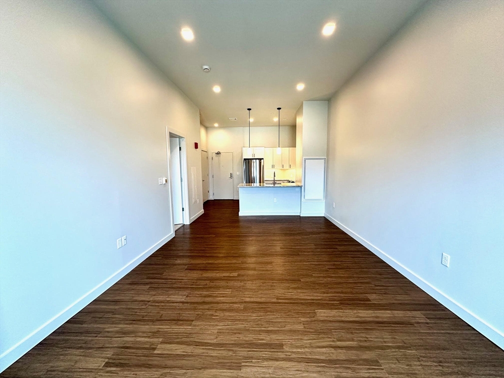 45 East Central Street, Unit 405 Natick, MA 01760 - Photo 4 of 21 a view of a living room with wooden floor