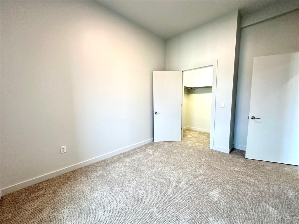 45 East Central Street, Unit 405 Natick, MA 01760 - Photo 8 of 21 an empty room with a natural light