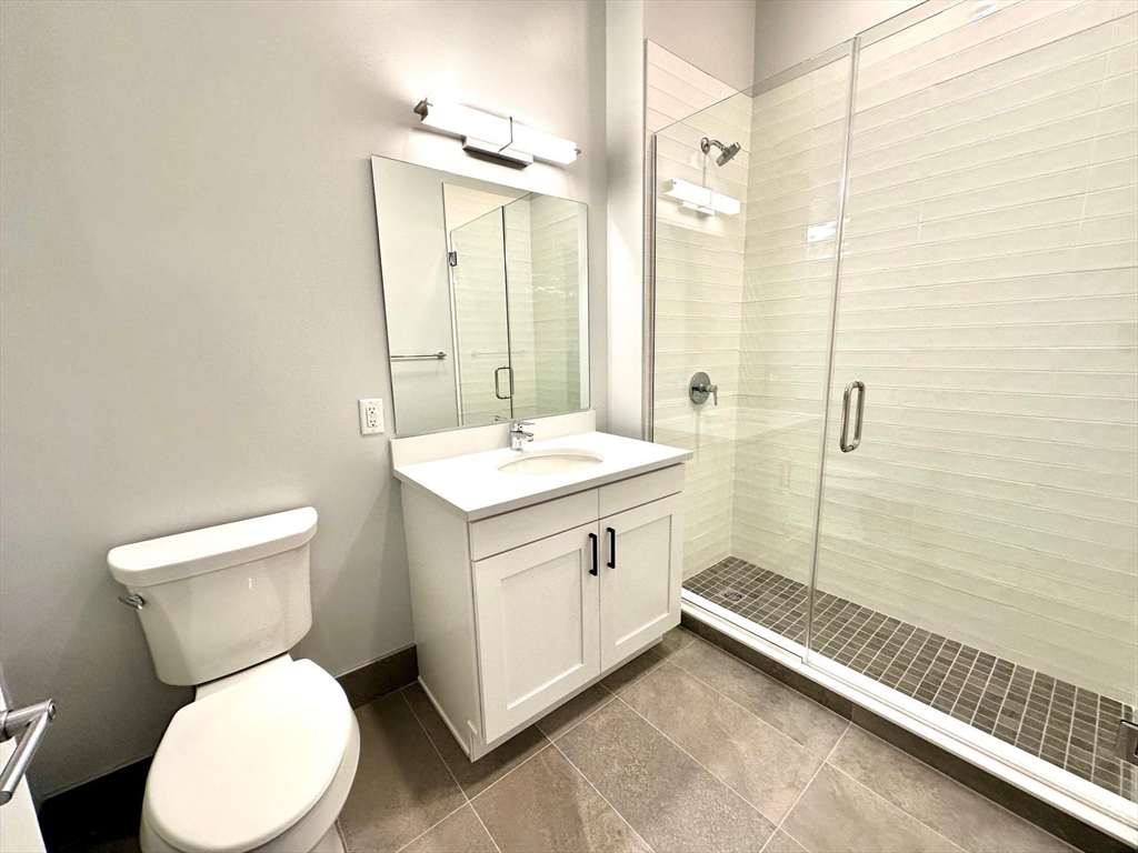 45 East Central Street, Unit 405 Natick, MA 01760 - Photo 9 of 21 a bathroom with a toilet sink and mirror