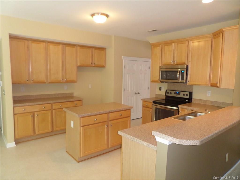 13313 Chelsea Ridge Lane Huntersville, NC 28078 - Photo 2 of 10 a kitchen with granite countertop white cabinets and stainless steel appliances