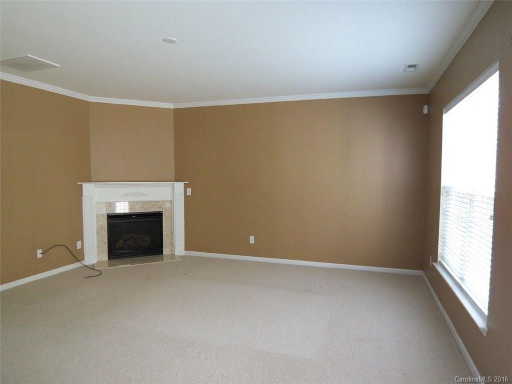 13313 Chelsea Ridge Lane Huntersville, NC 28078 - Photo 3 of 10 a view of empty room with a fireplace