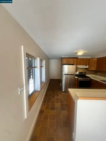 a kitchen with a refrigerator and a sink