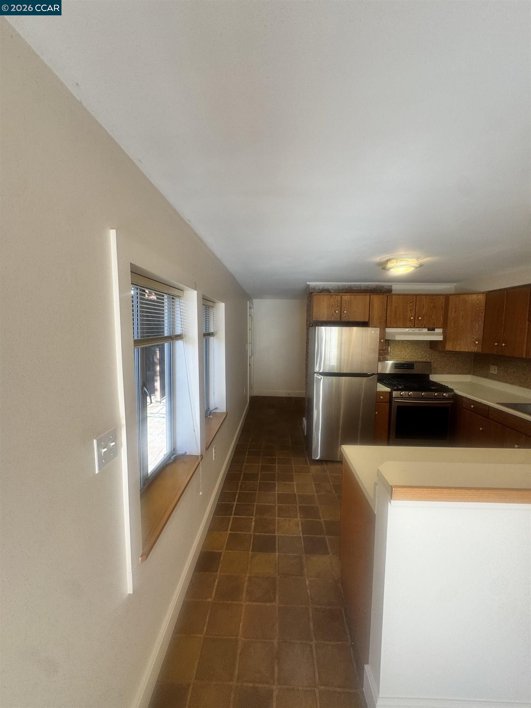 1723 Carleton Street, Unit A Berkeley, CA 94703 - Photo 13 of 32 a kitchen with a refrigerator and a sink