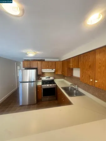 a kitchen with a refrigerator and a sink