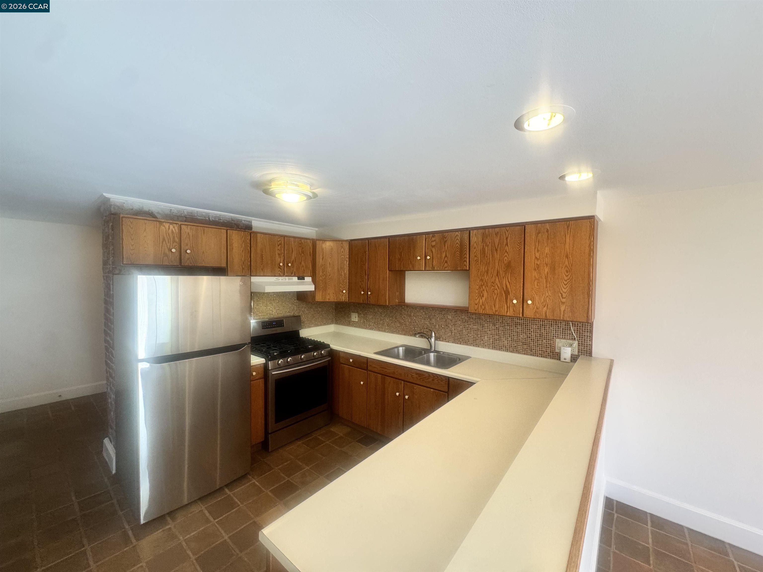 1723 Carleton Street, Unit A Berkeley, CA 94703 - Photo 16 of 32 a kitchen with a refrigerator sink and cabinets