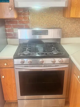 a stove top oven sitting inside of a kitchen