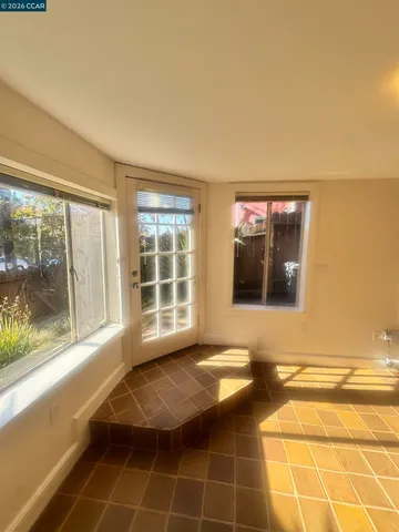 a view of a livingroom with wooden floor and a large window