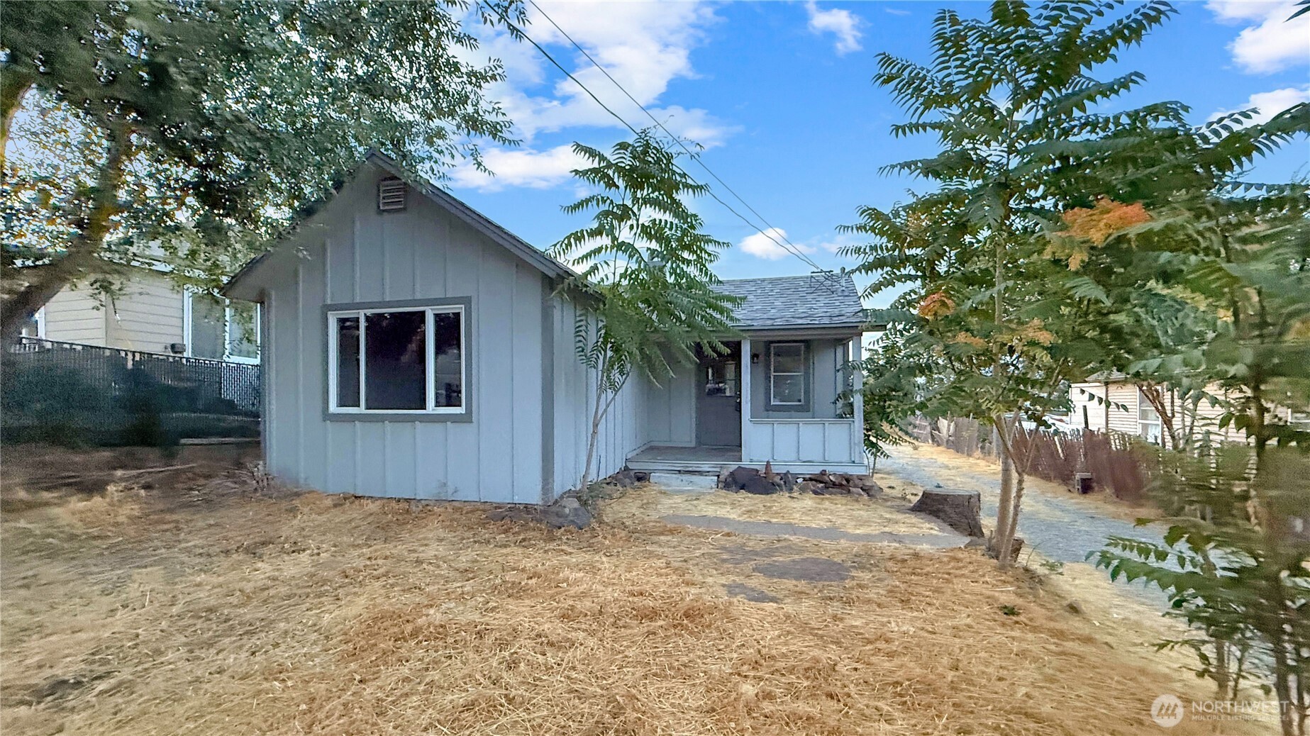 a view of a house with a tree and a yard