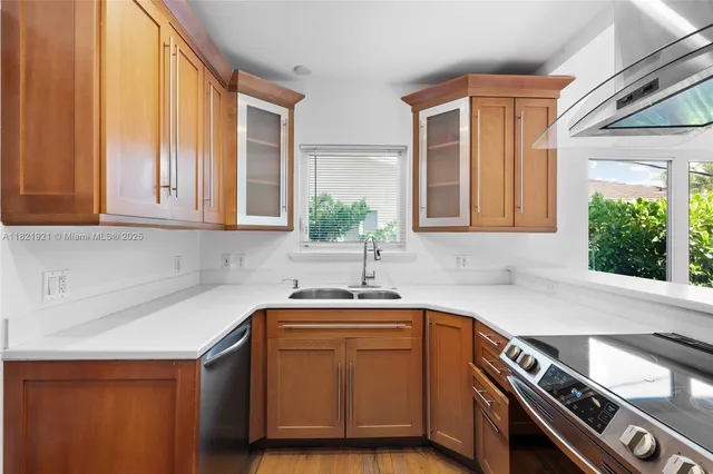 a kitchen with stainless steel appliances granite countertop a stove and a sink