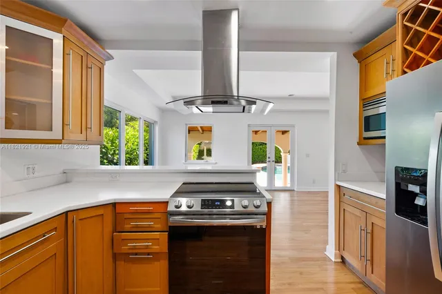 a kitchen with stainless steel appliances granite countertop a refrigerator and a stove