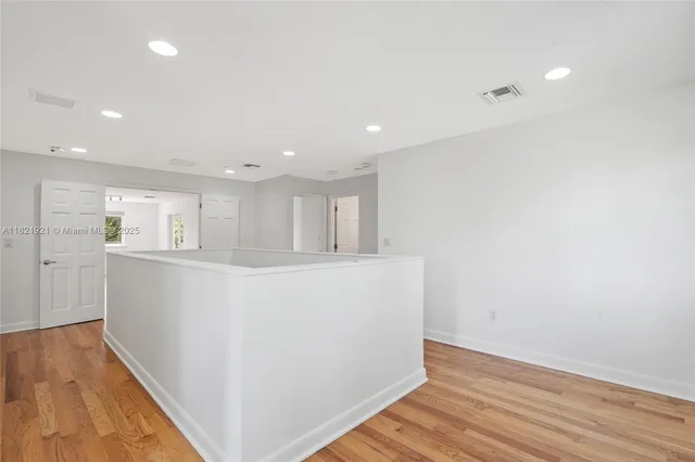 a spacious bathroom with a tub sink and mirror