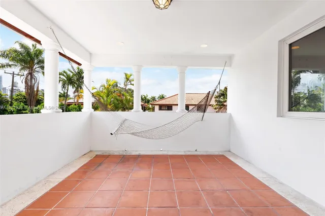 an empty room with a window and wooden floor
