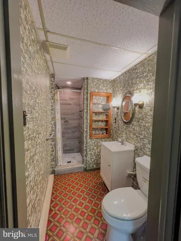 a bathroom with a toilet and shower