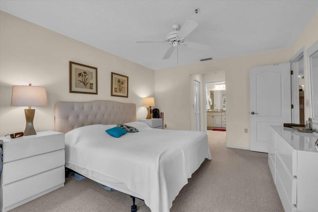 6713 Stone River Road, Unit 206 Bradenton, FL 34203 - Photo 26 of 58 a bedroom with a bed and a lamp