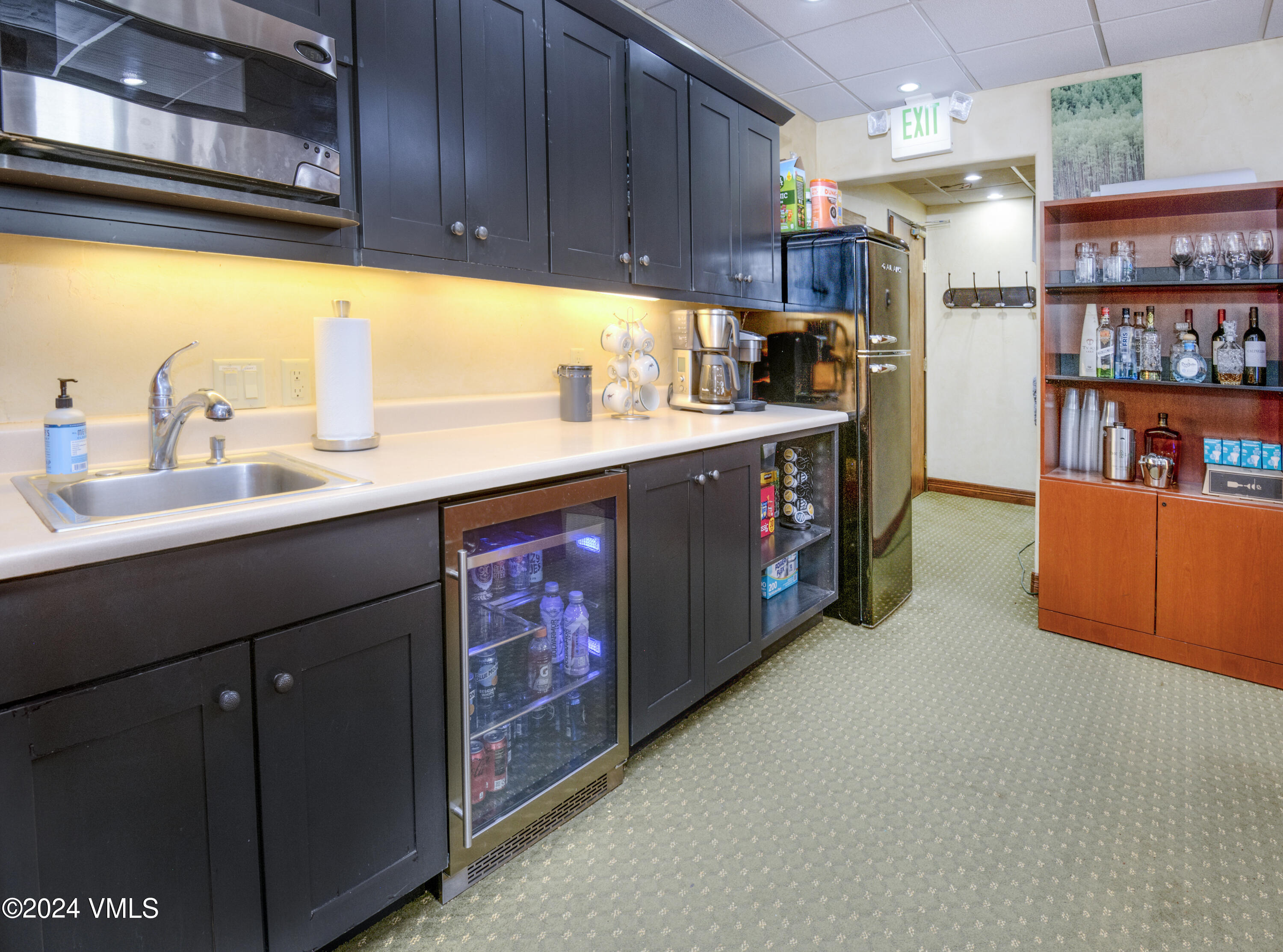 63 Avondale Lane, Unit C001 Beaver Creek, CO 81620 - Photo 11 of 24 a kitchen with stainless steel appliances granite countertop a refrigerator a sink and a stove