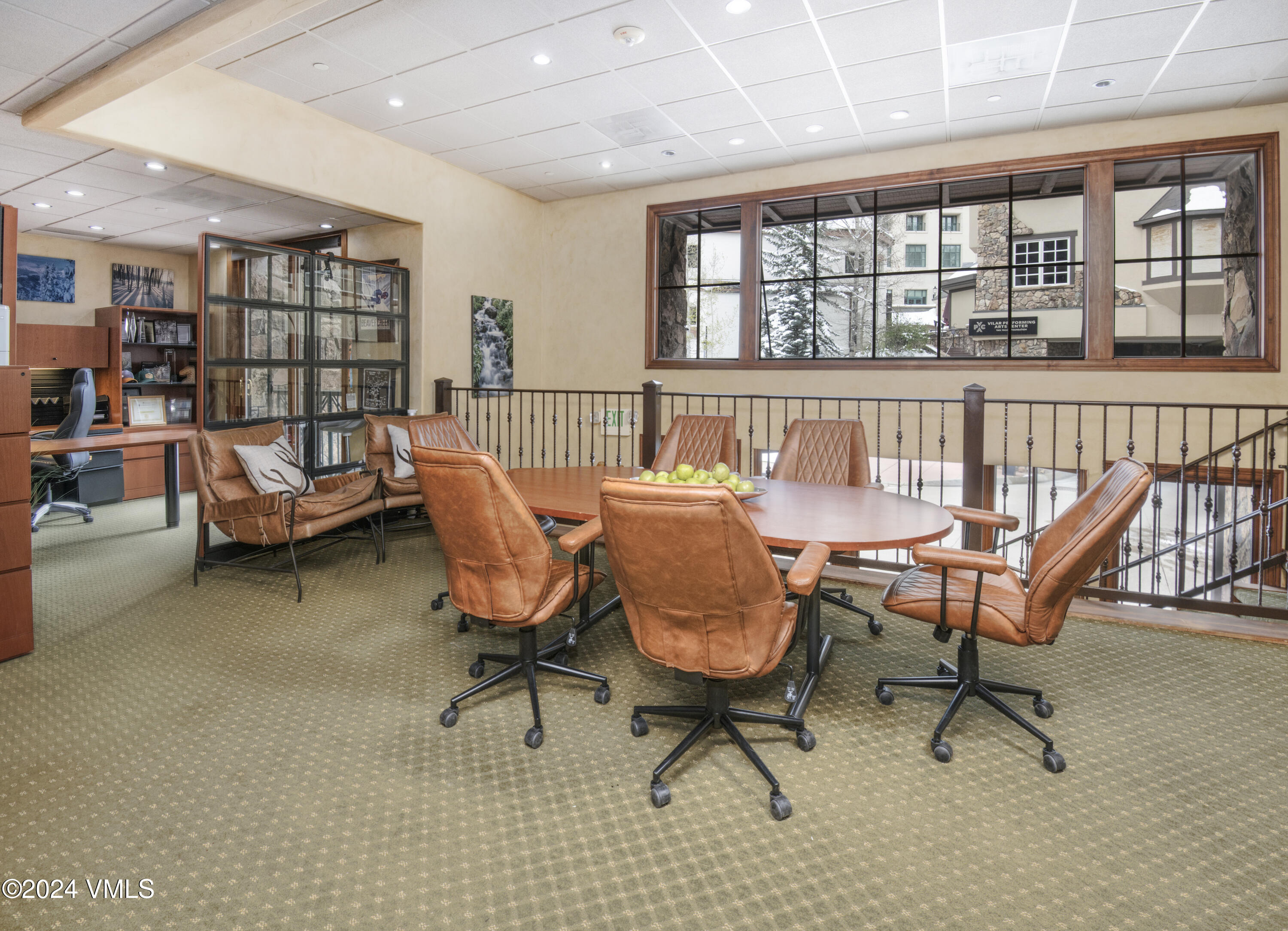 63 Avondale Lane, Unit C001 Beaver Creek, CO 81620 - Photo 7 of 24 a living room with furniture a rug and a book shelf