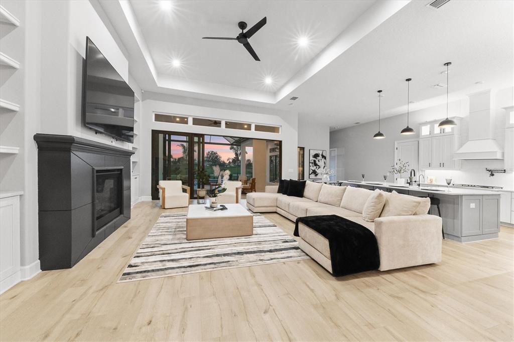 15013 Montello Way Bradenton, FL 34211 - Photo 14 of 100 a living room with furniture a fireplace and a flat screen tv