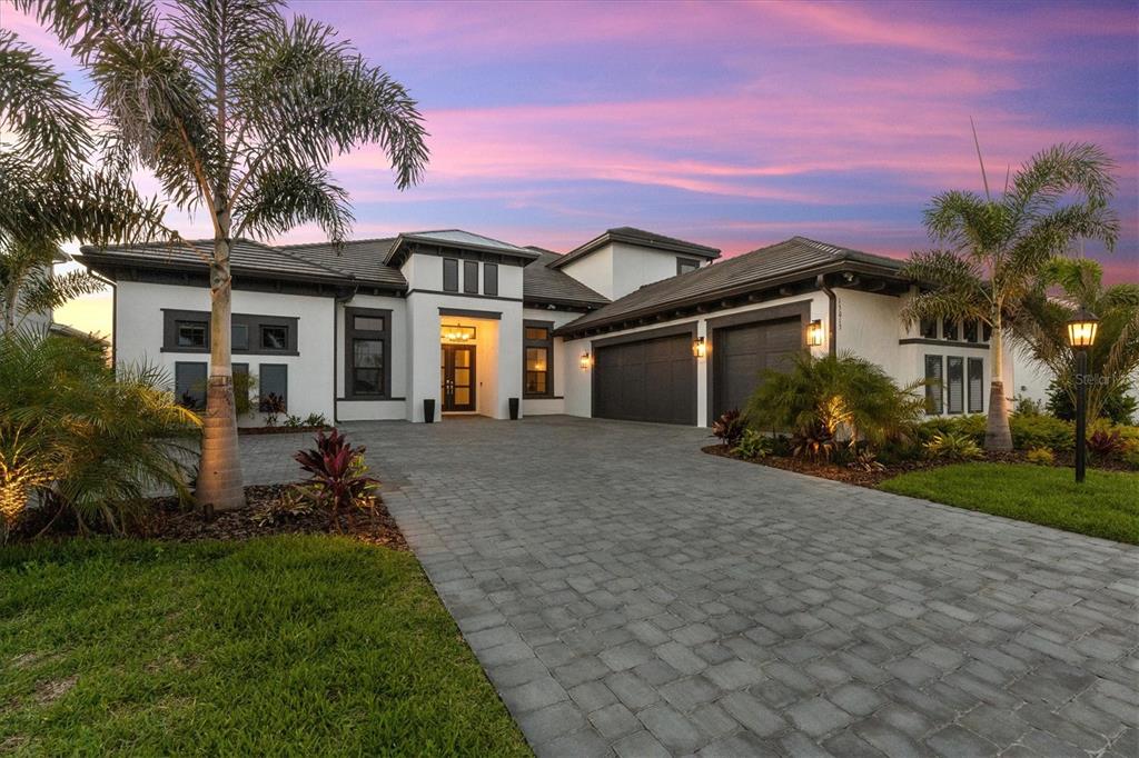 15013 Montello Way Bradenton, FL 34211 - Photo 2 of 100 a front view of a house with a garden and yard