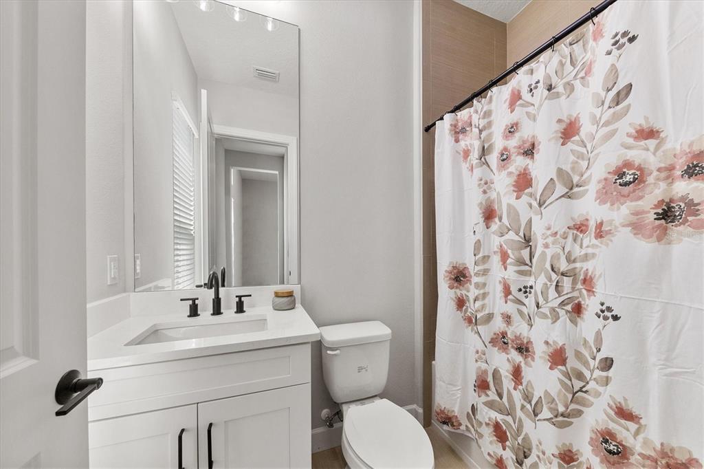 15013 Montello Way Bradenton, FL 34211 - Photo 31 of 100 a bathroom with a sink and mirror with toilet