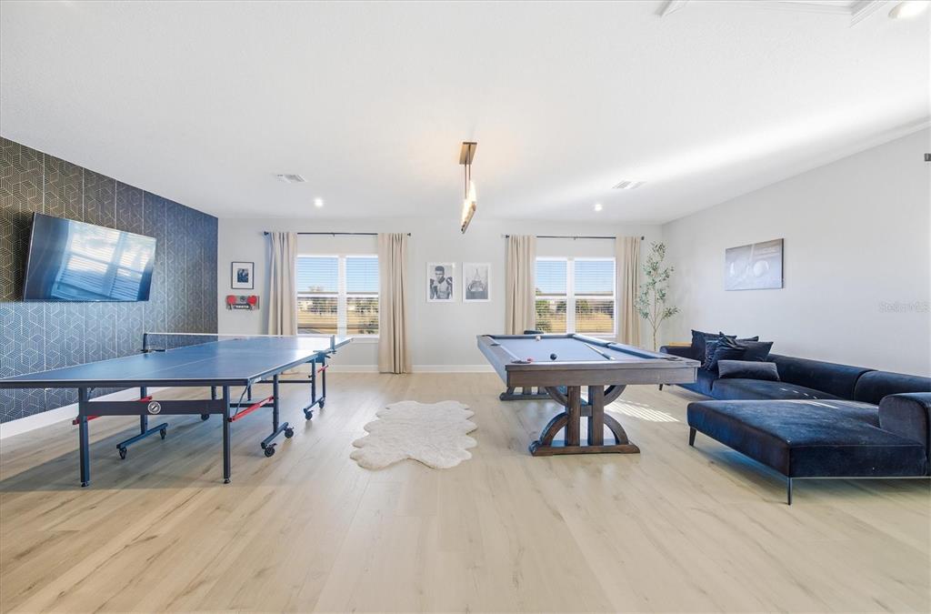 15013 Montello Way Bradenton, FL 34211 - Photo 39 of 100 a living room with furniture a table and a potted plant