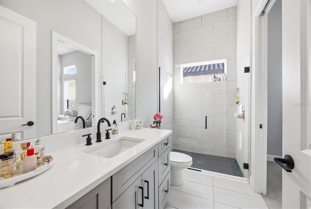 15013 Montello Way Bradenton, FL 34211 - Photo 42 of 100 a bathroom with a sink a toilet and shower