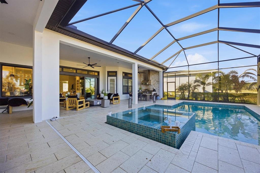 15013 Montello Way Bradenton, FL 34211 - Photo 51 of 100 a view of a patio with dining table and chairs under an umbrella
