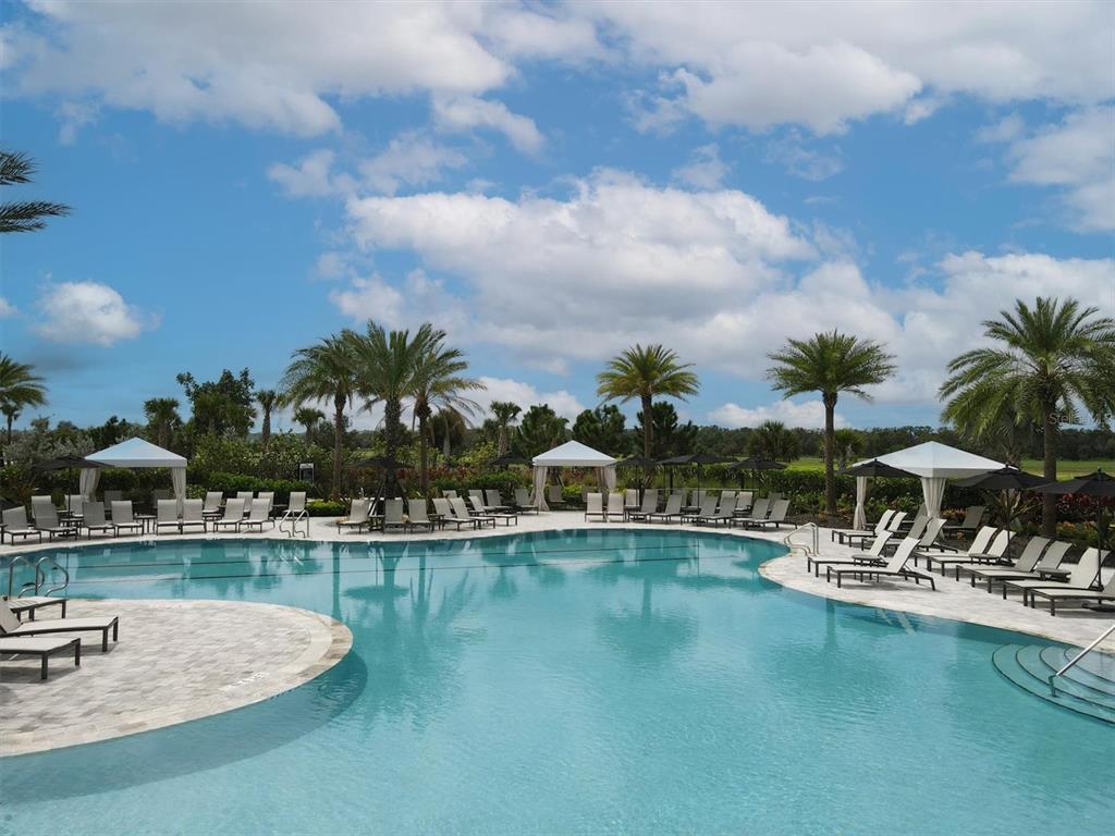 15013 Montello Way Bradenton, FL 34211 - Photo 88 of 100 a view of a swimming pool with a table and chairs