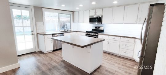 237 West Rader Avenue Ridgecrest, CA 93555 - Photo 9 of 37 a kitchen with white cabinets and a refrigerator