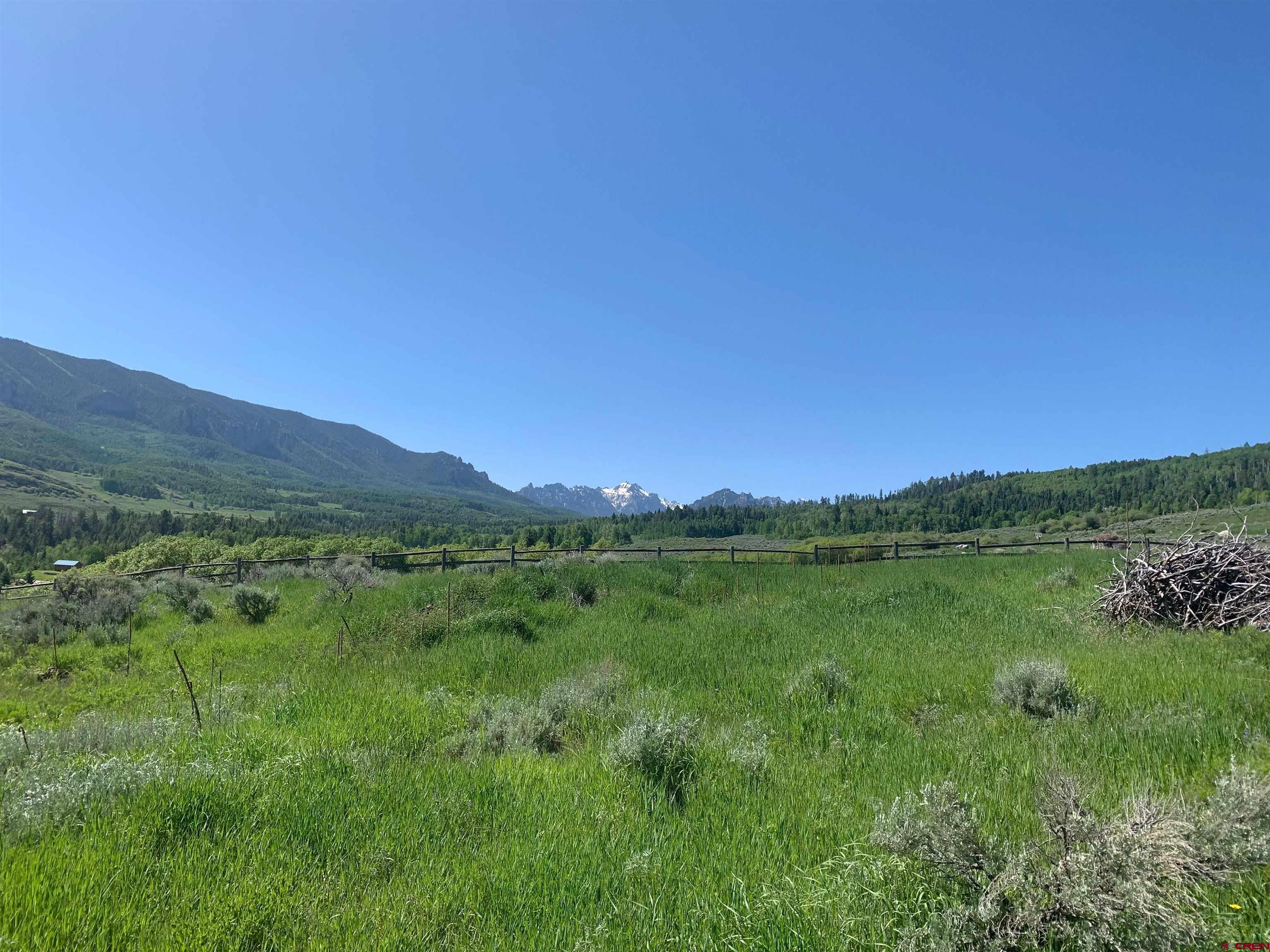 289 Eagles Rest Montrose, CO 81220 - Photo 2 of 8 a view of a lush green hillside and a houses