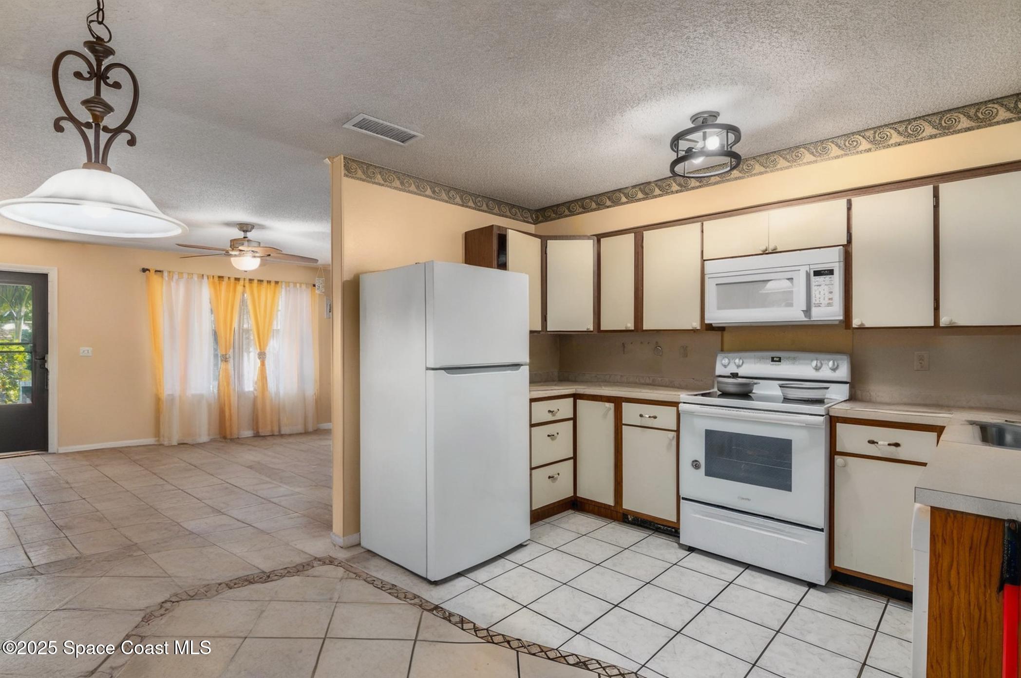 722 Venus Drive Cocoa, FL 32926 - Photo 7 of 17 a kitchen with appliances cabinets and a sink
