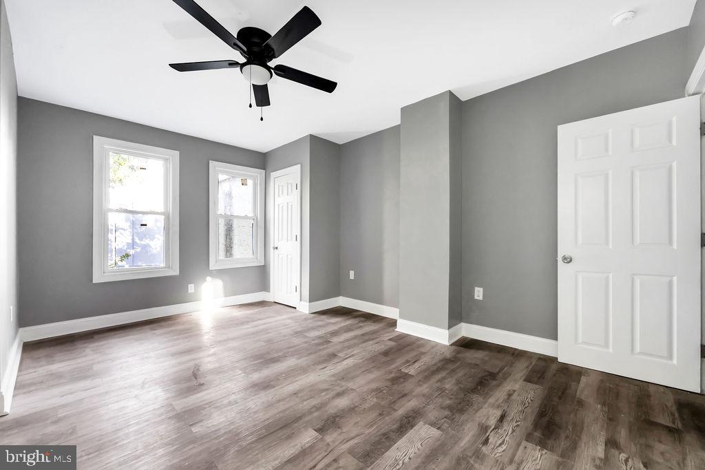 606 South 52nd Street Philadelphia, PA 19143 - Photo 4 of 16 a view of an empty room with window and wooden floor