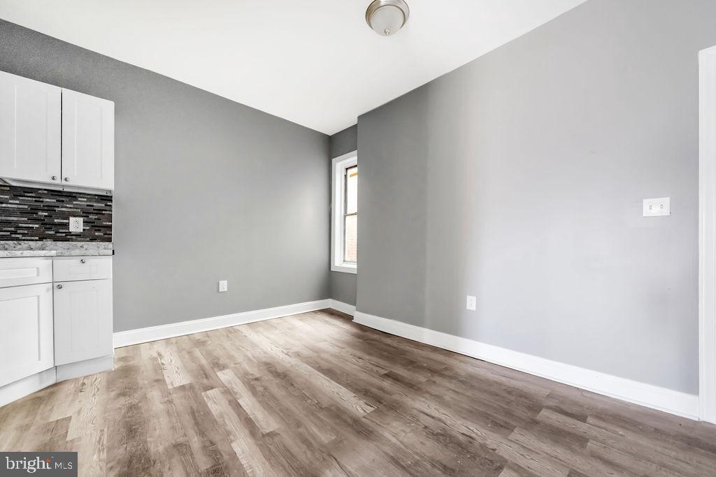 606 South 52nd Street Philadelphia, PA 19143 - Photo 7 of 16 a view of an empty room with wooden floor