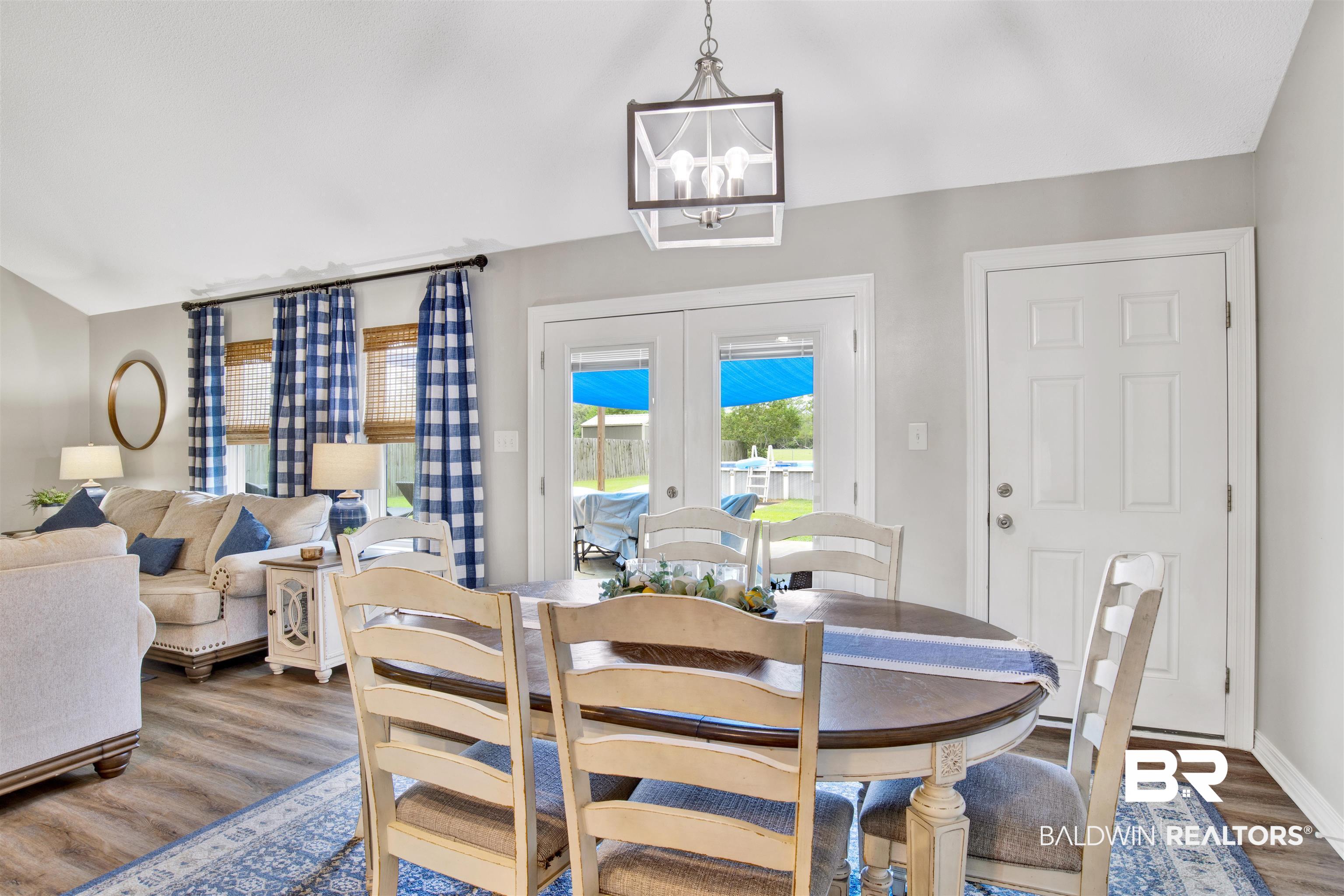 17483 East View Loop Foley, AL 36535 - Photo 12 of 30 Dining room featuring hardwood / wood-style floors, an inviting chandelier, and french doors