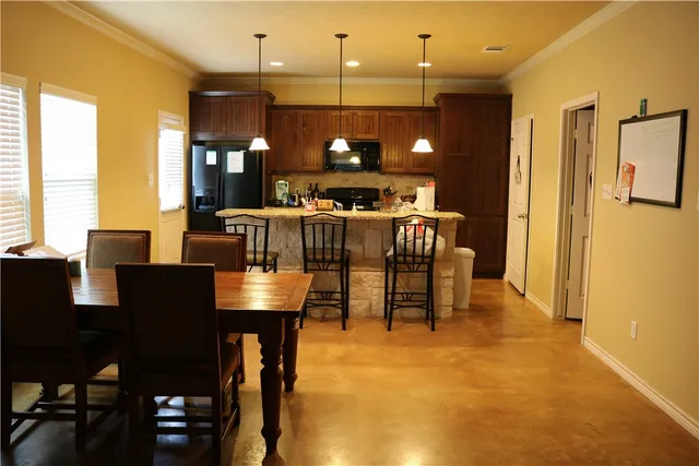 a view of a dining room with furniture and window