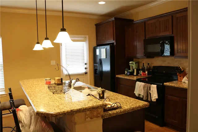 a kitchen with a table chairs and a refrigerator