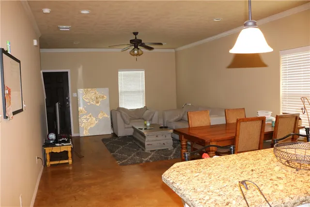 a living room with furniture a window and a flat screen tv