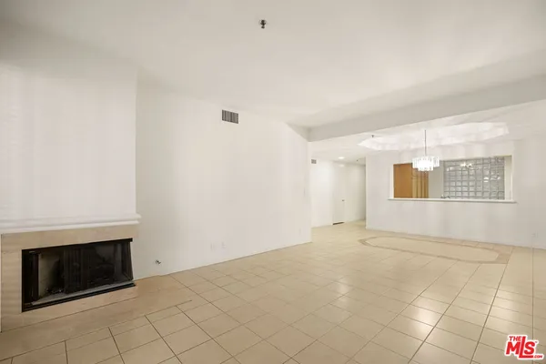 a view of an empty room with a fireplace