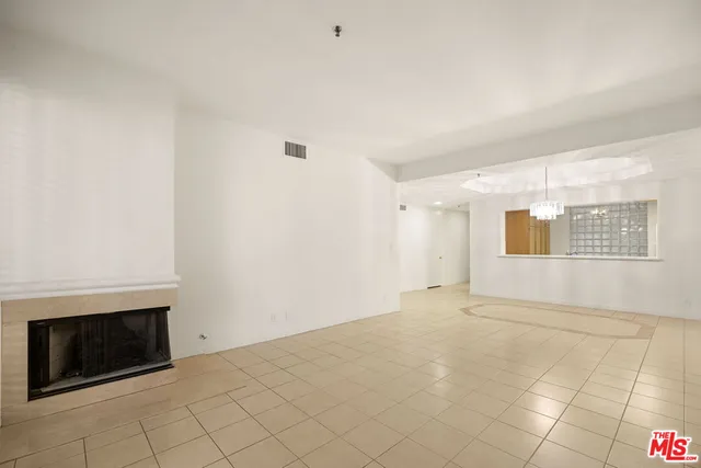 a view of an empty room with a fireplace