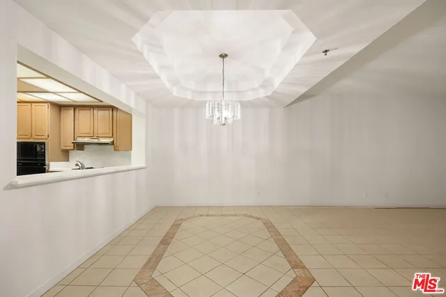 a view of a kitchen with granite countertop white cabinets and stainless steel appliances