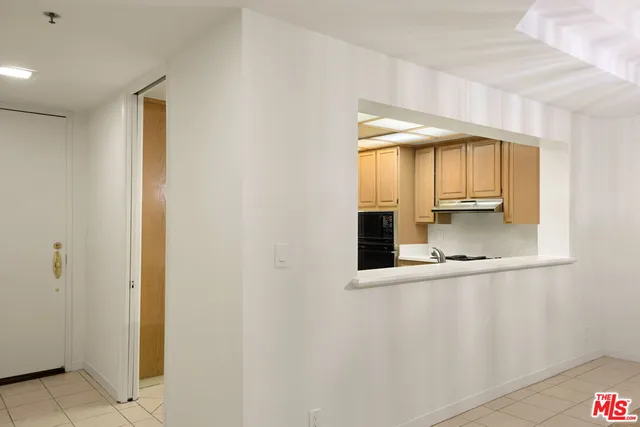 a view of a hallway with wooden shelves