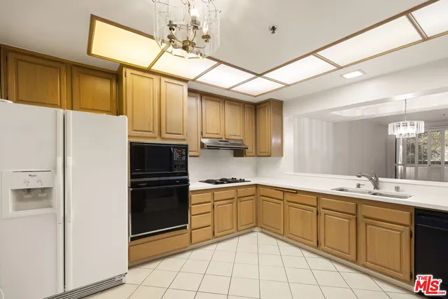 a kitchen with a sink appliances and cabinets