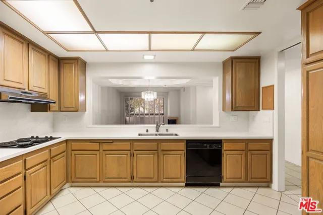 a kitchen with a sink cabinets and window