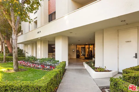 a front view of a house with a yard and flowers