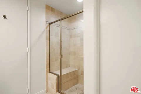 a bathroom with a glass shower door